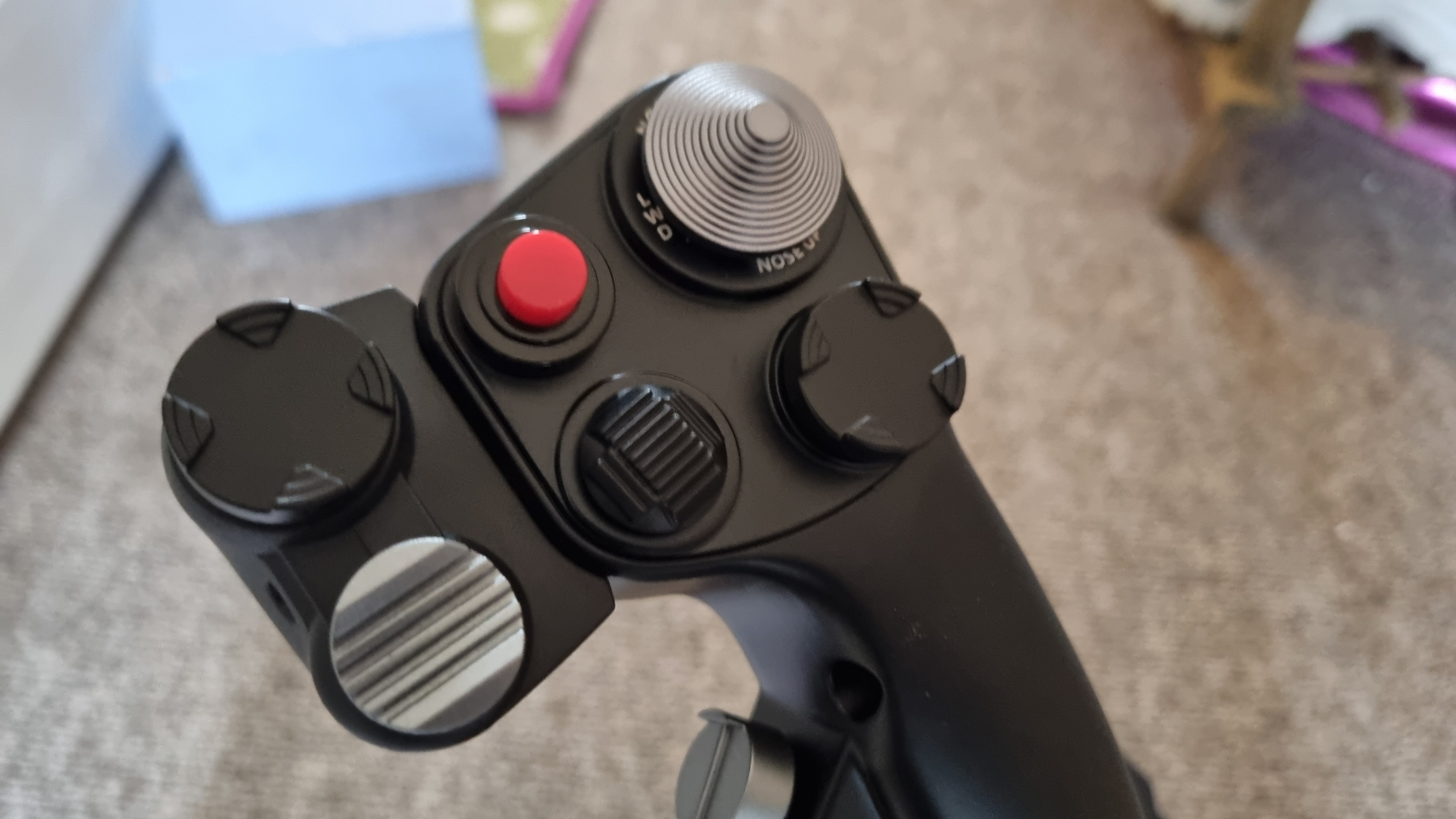 The top of the Moza MH16 Flightstick, showing a selection of buttons and hats