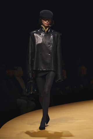 A runway model wearing a F/W 2025 Khaite outfit.