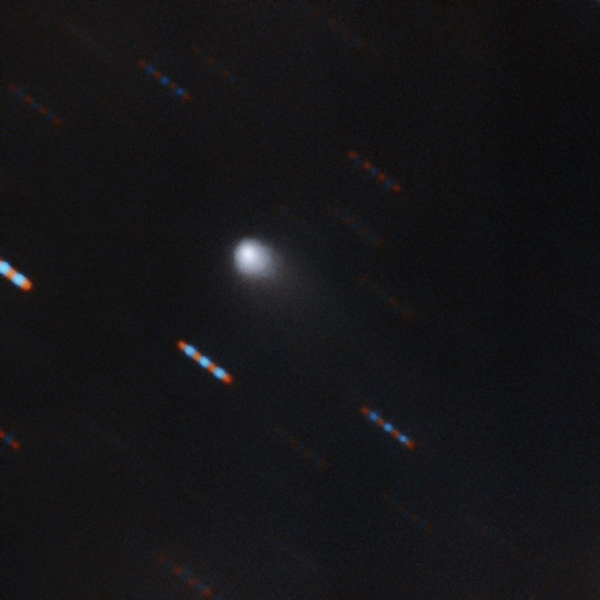 The first color image of the comet 2I/Borisov, the first known interstellar comet ever identified, was captured by the Gemini North telescope at Hawaii&#039;s Mauna Kea. Gemini North acquired four 60-second exposures in two color bands (red and green). The blue and red lines are background stars moving in the background.