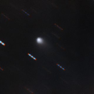 The first color image of the comet 2I/Borisov, the first known interstellar comet ever identified, was captured by the Gemini North telescope at Hawaii's Mauna Kea. Gemini North acquired four 60-second exposures in two color bands (red and green). The blue and red lines are background stars moving in the background.
