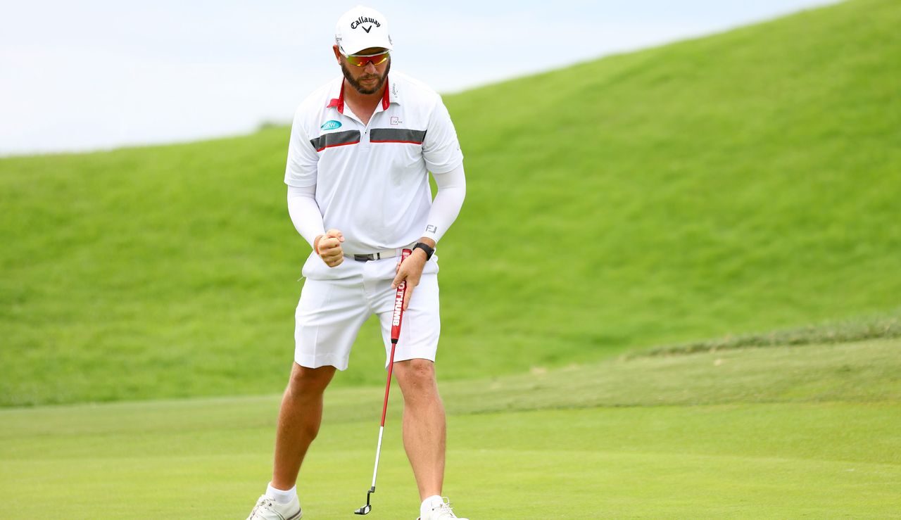 Ockie Strydom fist pumps as he holes the putt