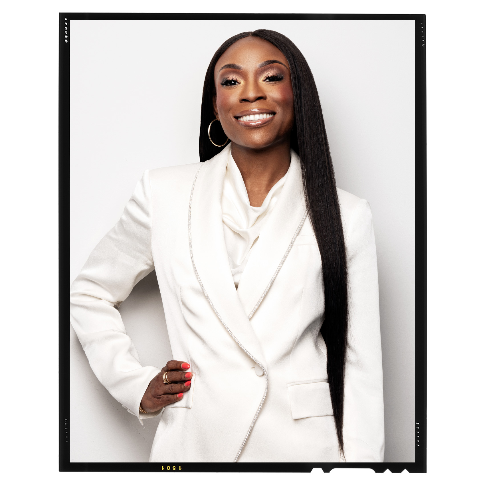 portrait of Dara Treseder in a white suit against a white background