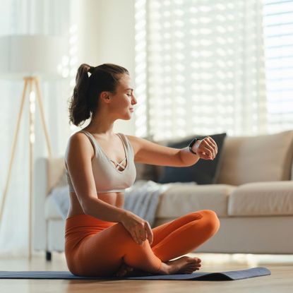 A woman doing a living room workout at home