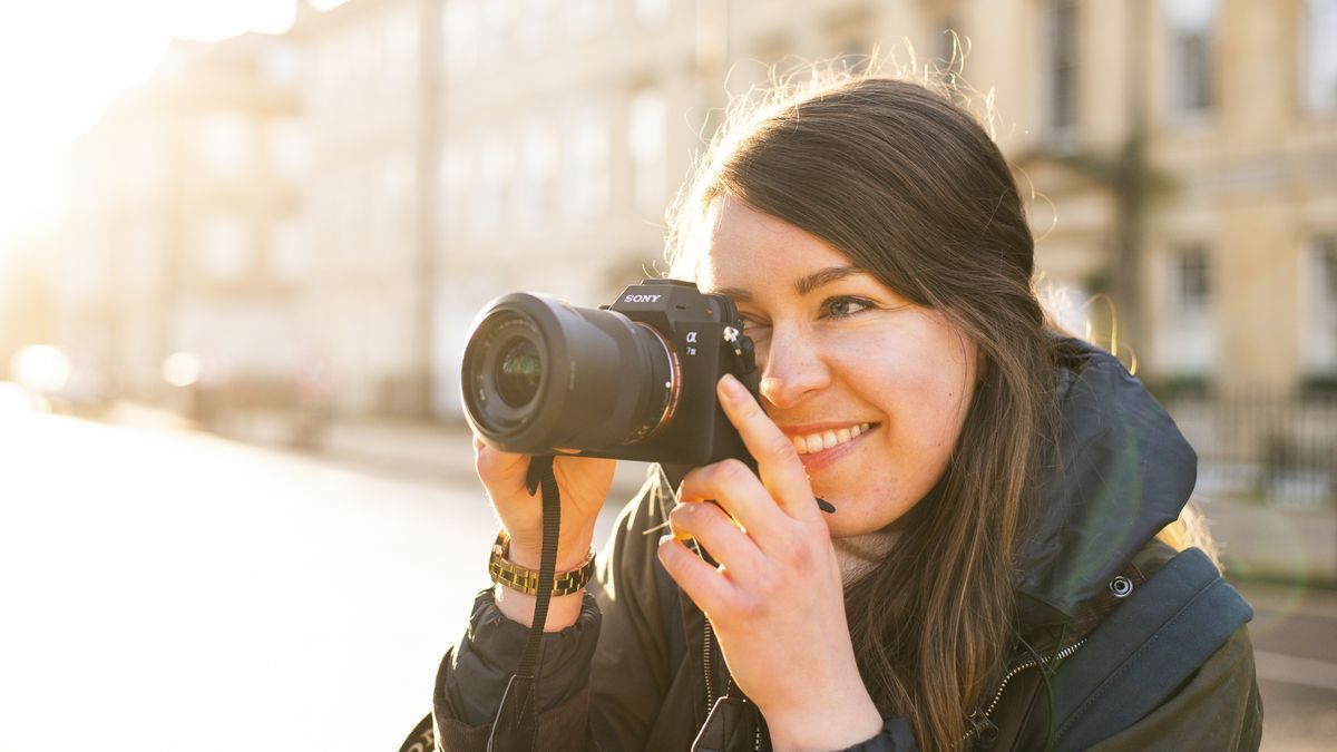 A photographer holding the Sony A7 III in backlit sun
