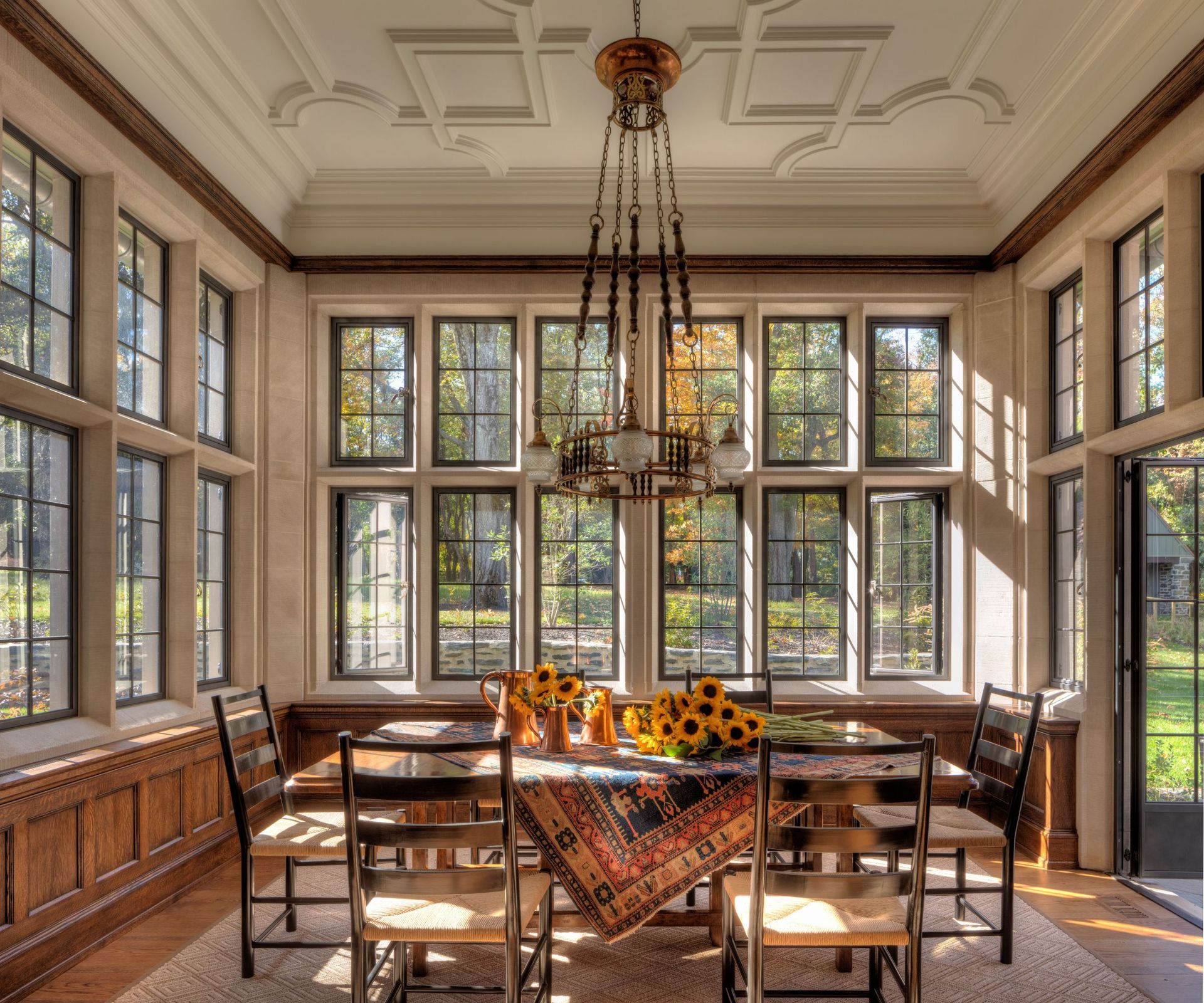 breakfast nook with sunflowers on table and windows all round