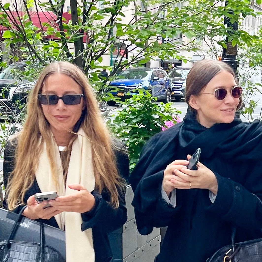 Mary-Kate and Ashley Olsen wearing jackets, scarves, jeans, bowling bags, and flat mules in NYC