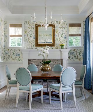 modern farmhouse dining room with floral wallpaper and an antique table