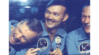 The Apollo 11 crew smiles in quarantine after their mission. From left, astronauts Neil Armstrong, Michael Collins and Buzz Aldrin.