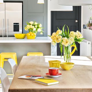 kitchen with yellow stool and flowers