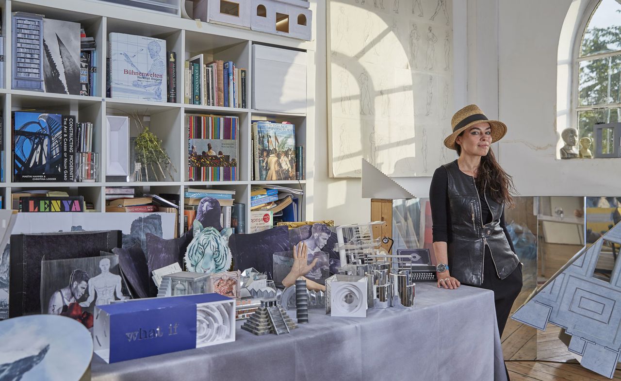 Es Devlin in her peckham HQ, surrounded by props and mock-ups, including a model of the Mirror Maze she created for Chanel