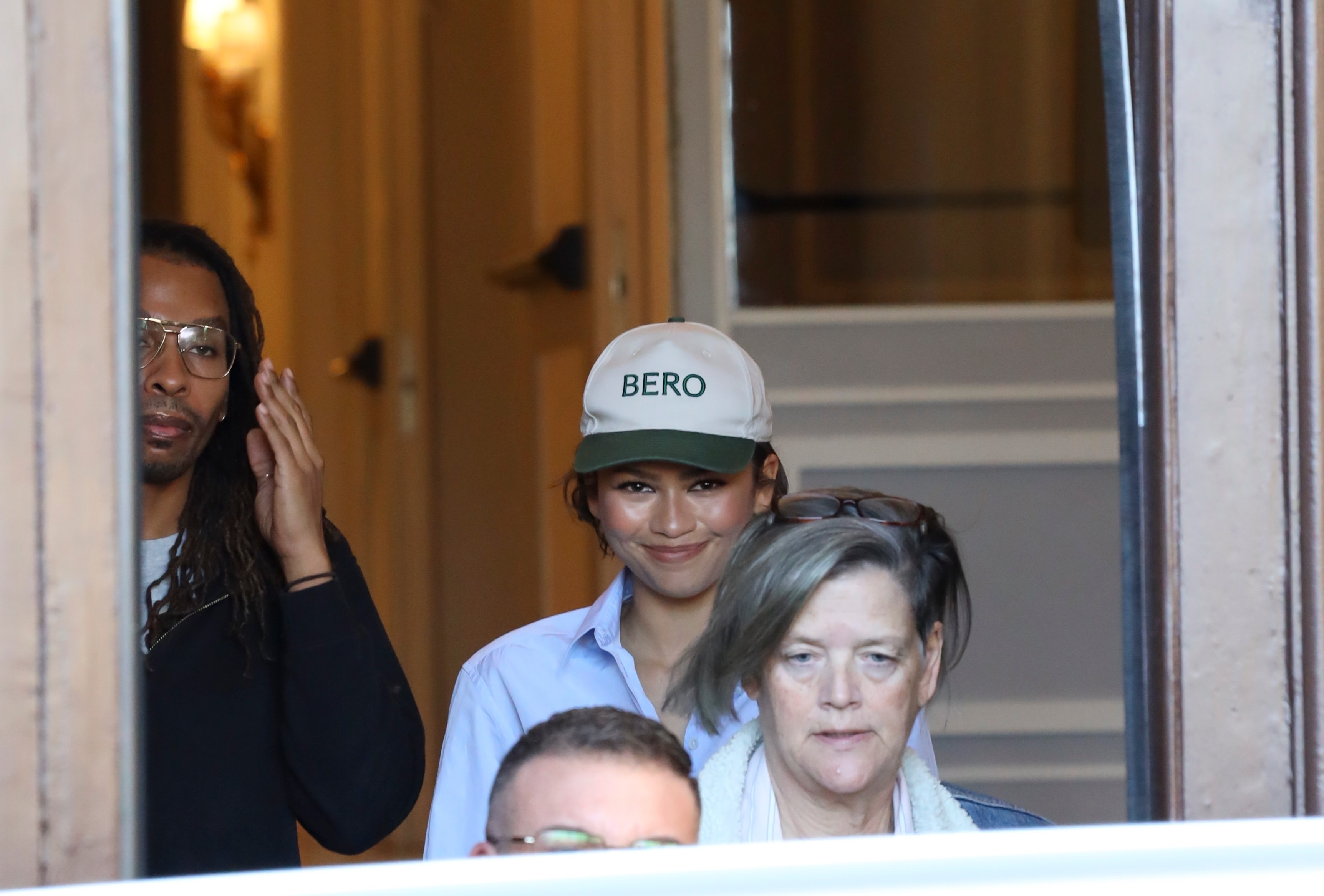 Zendaya wearing a Bero cap, referencing rumored husband Tom Holland's brand during a shopping trip in Rome, Italy, paired with cuffed jeans, a shirt, and The Row loafers