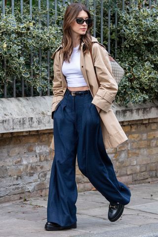 daisy edgar jones wearing a trench coat and wide leg jeans