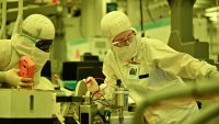 Intel engineers working in a clean room environment.