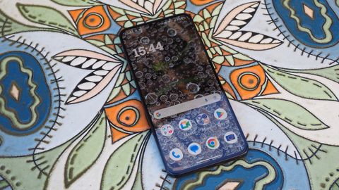 A blue Moto Edge 50 Neo on a flowery background