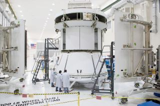 NASA engineers ready the Orion EFT-1 mock service module for installation of the fairings that will protect it during launch when Orion lifts off on its first mission, now slated for December 2014.