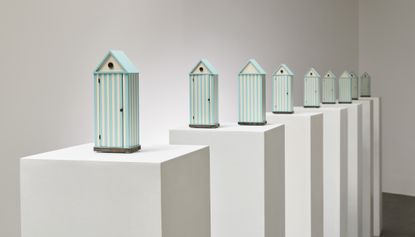 Models of Cabina dell'Elba – beach hut-inspired wardrobes – by Aldo Rossi on plinths in gallery