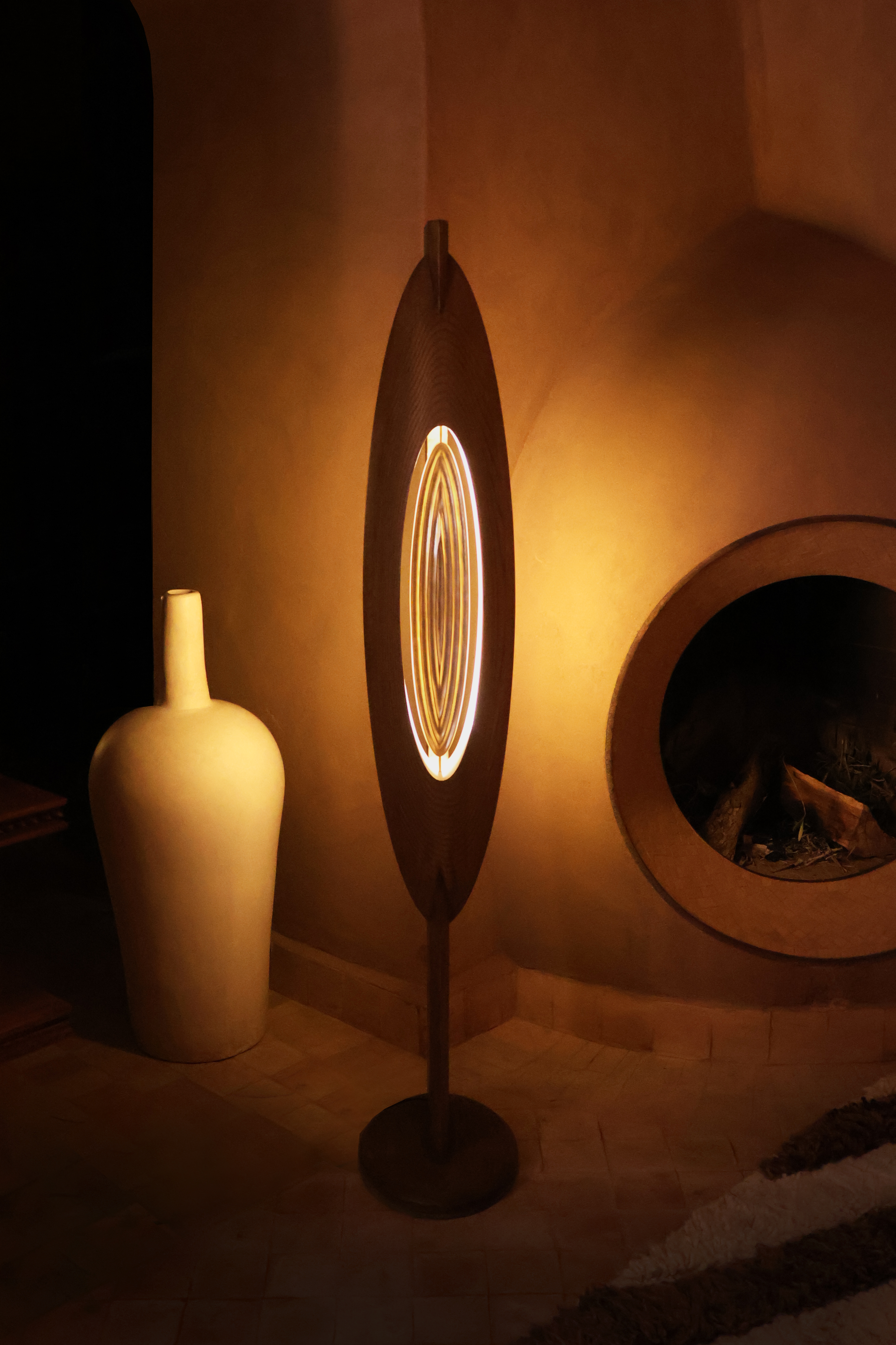 Lamp centred by wall and pottery