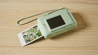 A matcha green Fujifilm Instax mini LiPlay 2-in-1 instant camera and printer