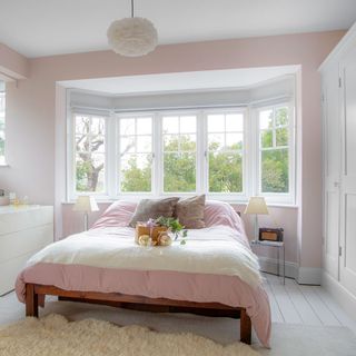 bedroom with french windows and wooden floor