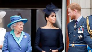 london, united kingdom july 10 embargoed for publication in uk newspapers until 24 hours after create date and time queen elizabeth ii, meghan, duchess of sussex and prince harry, duke of sussex watch a flypast to mark the centenary of the royal air force from the balcony of buckingham palace on july 10, 2018 in london, england the 100th birthday of the raf, which was founded on on 1 april 1918, was marked with a centenary parade with the presentation of a new queens colour and flypast of 100 aircraft over buckingham palace photo by max mumbyindigogetty images