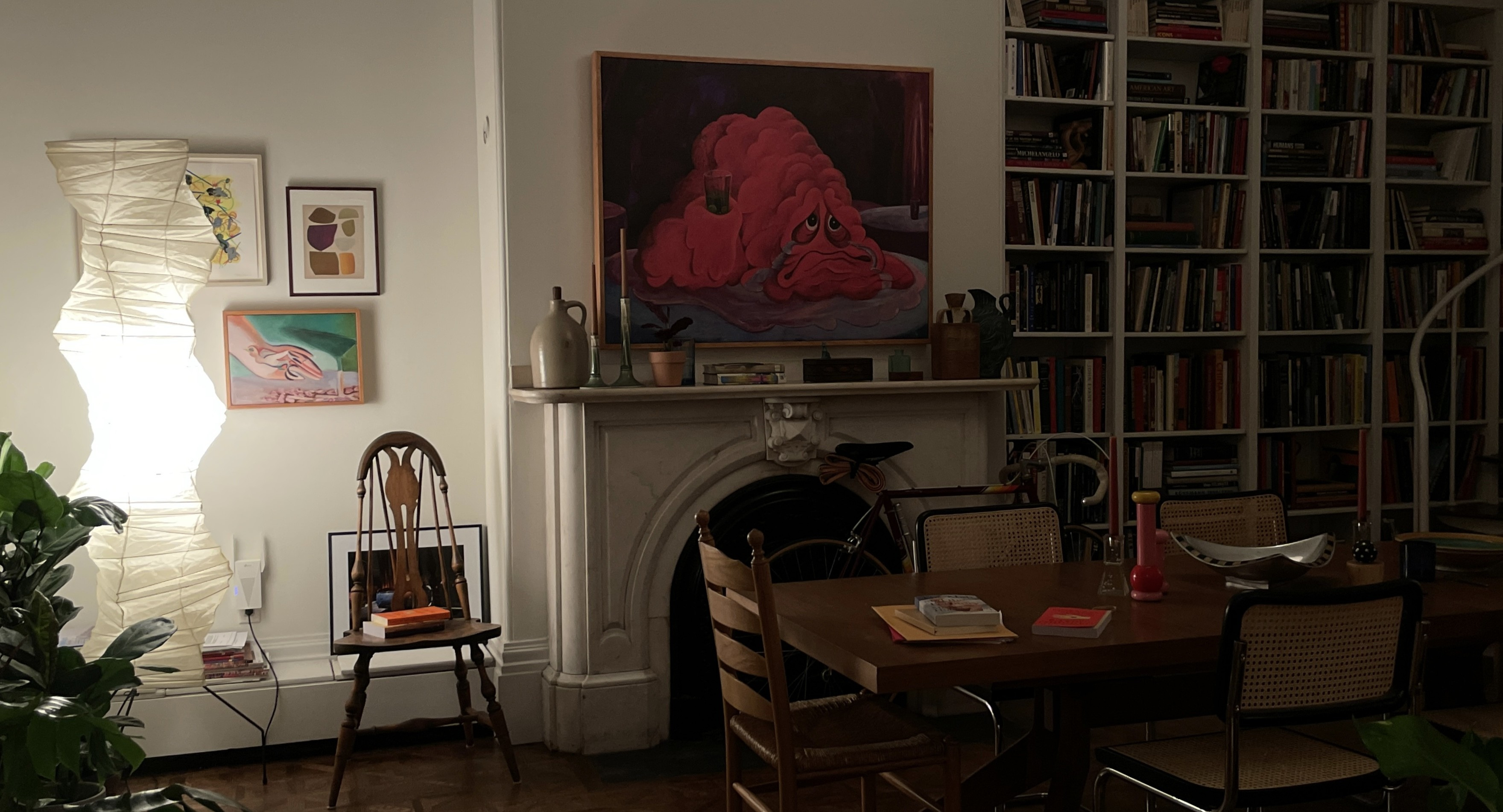 A series of interior shots of an art and objects-filled, dimly lit apartment, a museum's gallery rooms, an empty dance rehearsal room, and colorfully decorated office spaces.