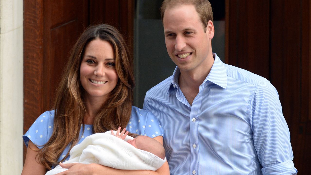 Kate Middleton and Prince William holding baby Prince George 