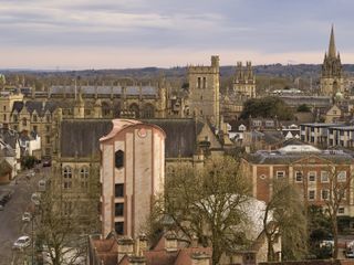 Gradel Quadrangles in Oxford with its pink hued exterior and curved shapes and gargoyles