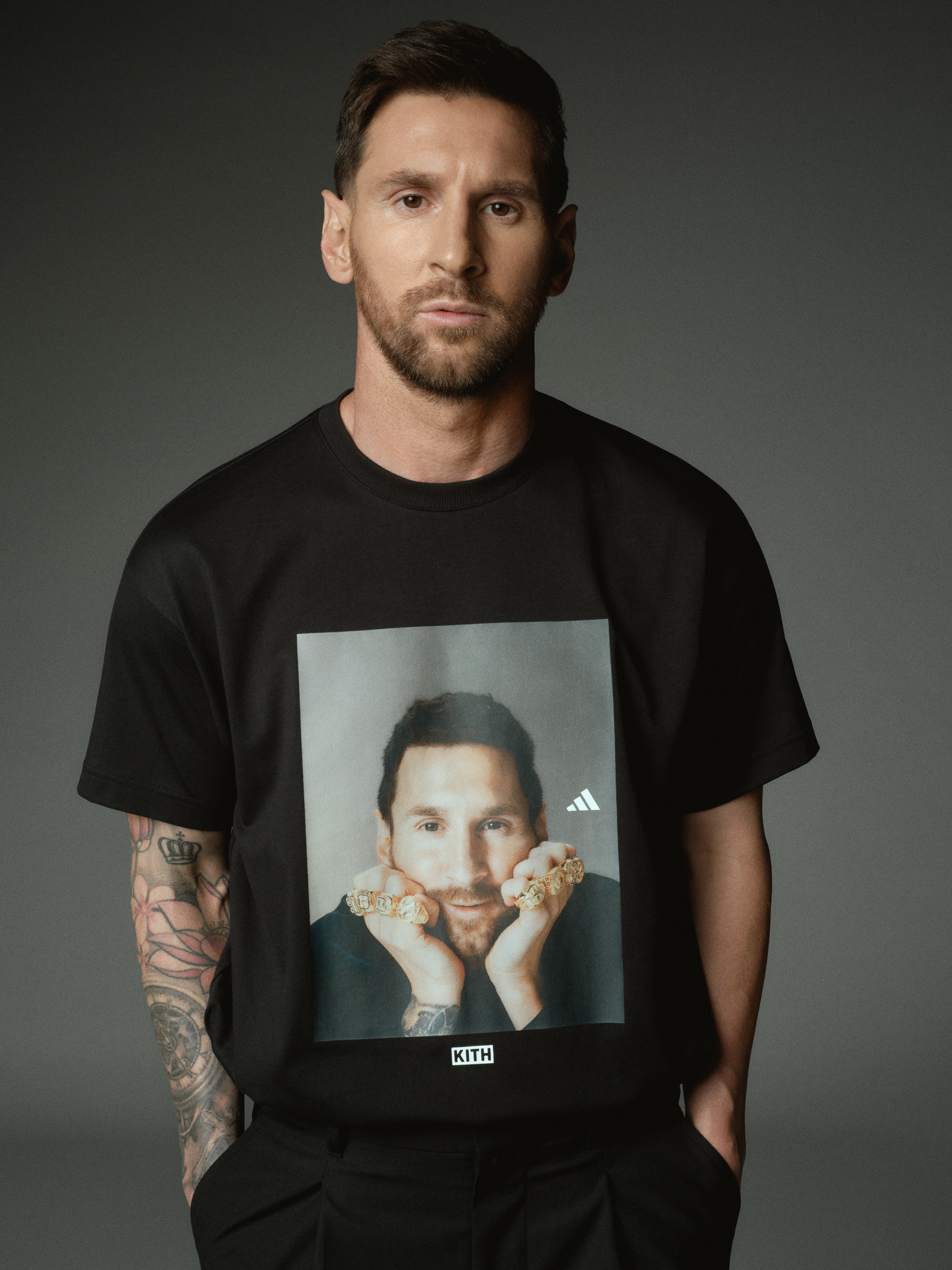 Lionel Messi posing in a graphic T-shirt from his Kith x Adidas x Lionel Messi collaboration collection.