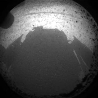 This photo shows the shadow of NASA's huge rover Curiosity on Mars just after its Aug. 5 PDT, 2012 landing in Gale Crater.