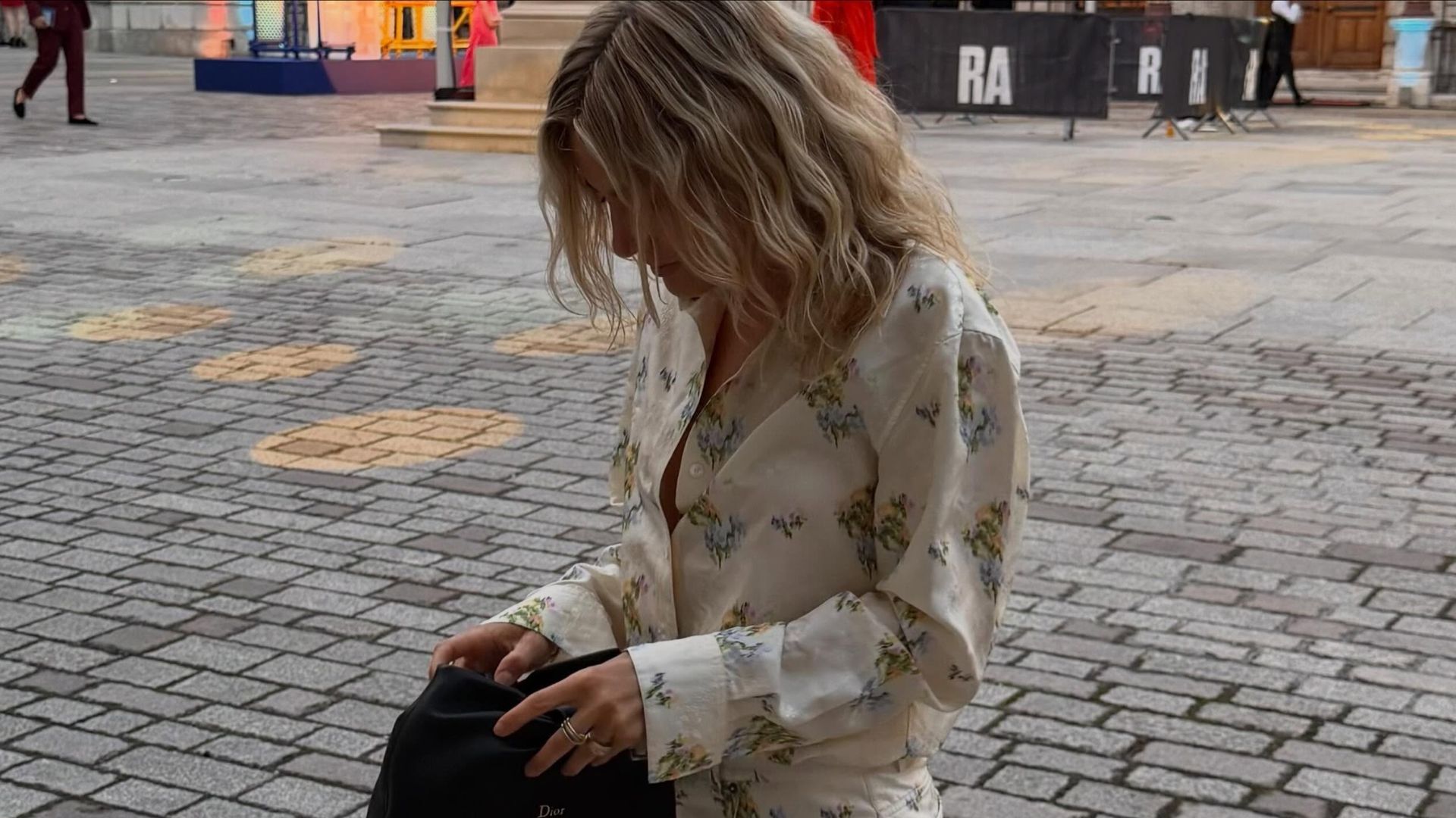 Influencer @lucywilliams02 wears a floral minidress with sculptural wedge thong heels.