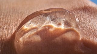 A close-up of aloe vera gel on a hand to treat sunburn
