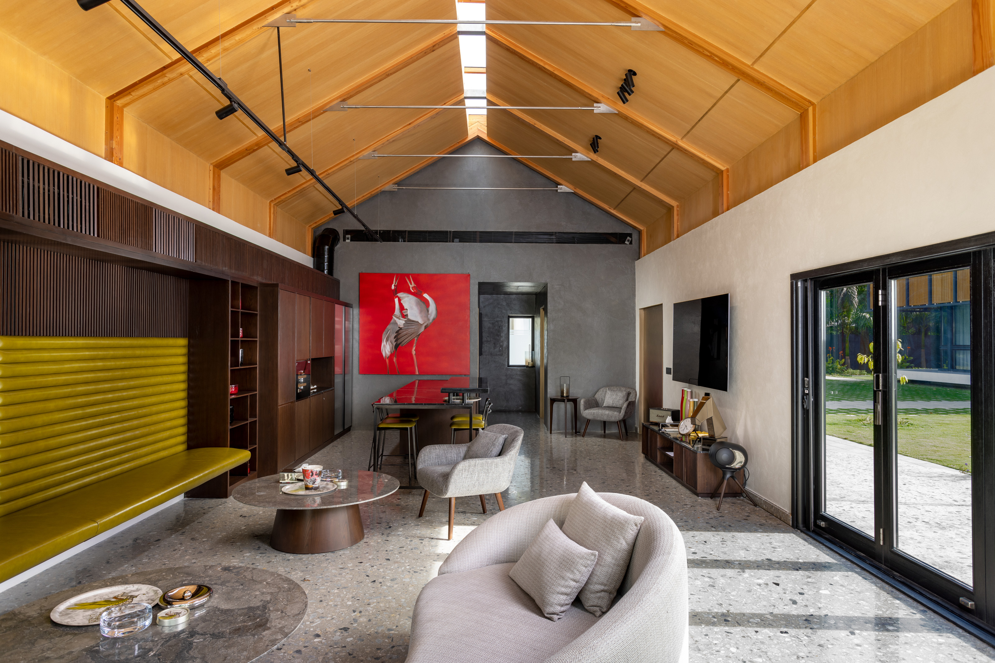 The family room with its timber clad ceiling and terrrazo floor