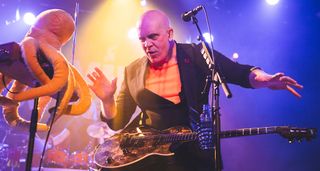 Devin Townsend bathed in multi-coloured stage lights