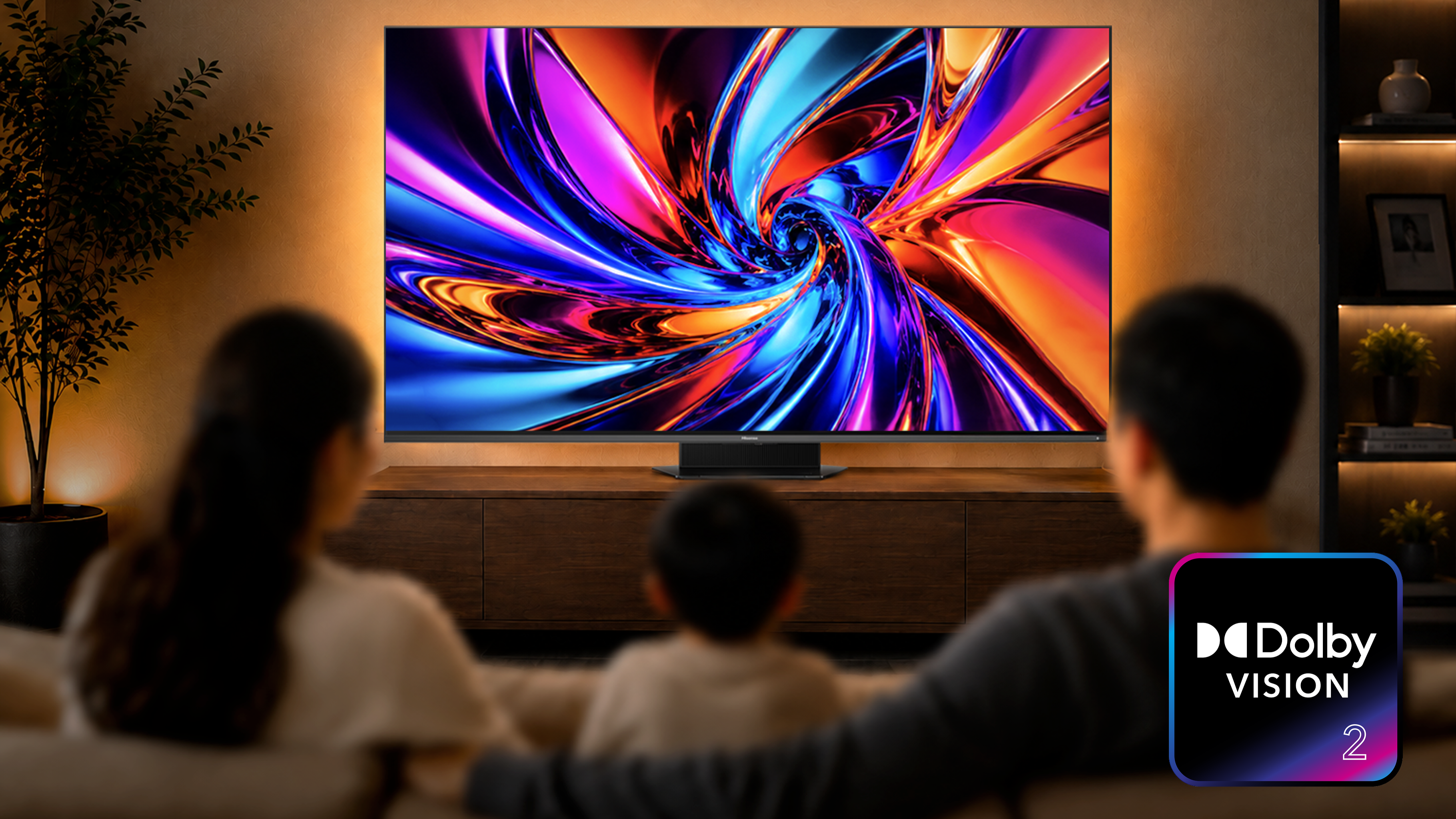 An image of a family watching a colourful swirl on TV with a Dolby Vision 2 logo in the bottom right corner
