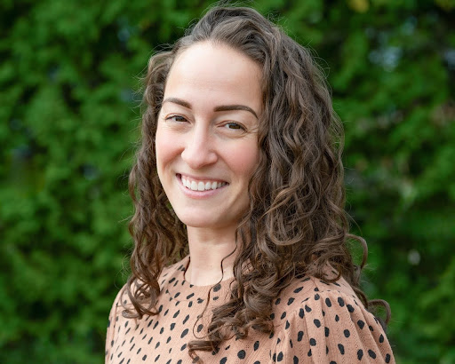 woman with brown hair and pink dotty top