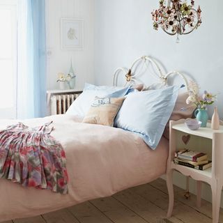 blue bedroom with bed and table
