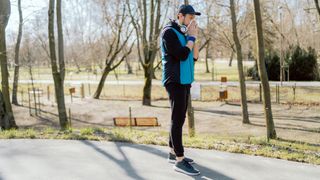 Runner in park blows nose