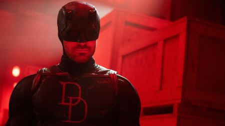 Daredevil wearing his black suit in a red-lit room in Daredevil: Born Again season 2