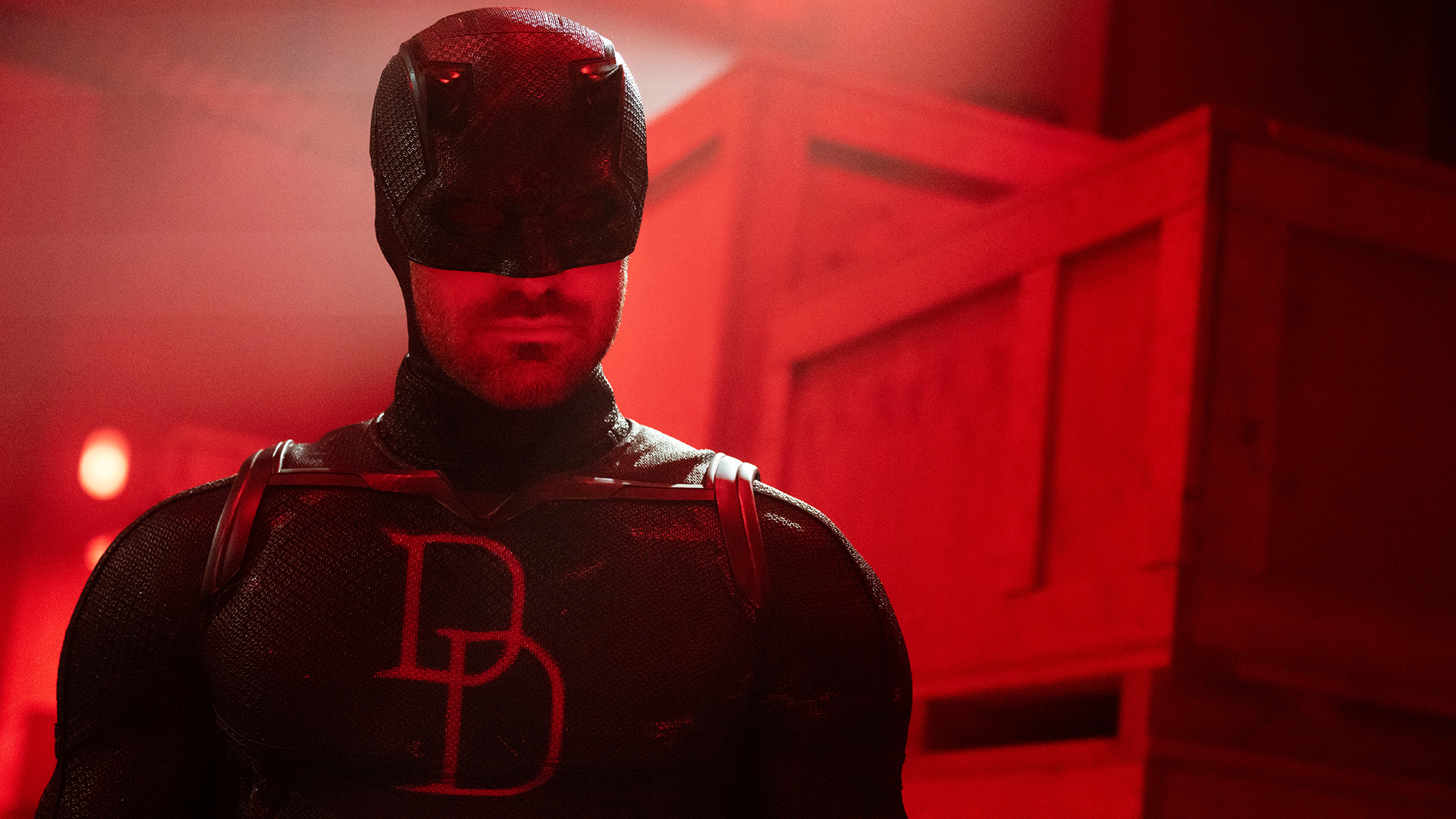 Daredevil wearing his black suit in a red-lit room in Daredevil: Born Again season 2