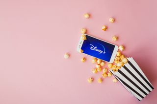 A smartphone with Disney+ and popcorn