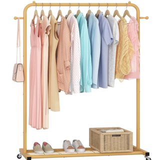 a tan colored capsule wardrobe with a wire rack underneath to hold shoes