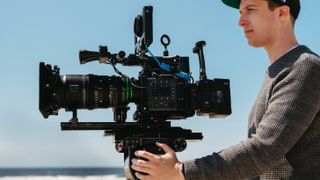 Fujifilm GFX Eterna 55 cinema camera on a tripod being operated by a videographer