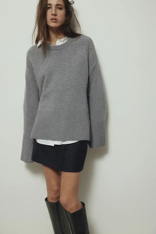 grey jumpers - woman wearing jumper with skirt and knee high boots
