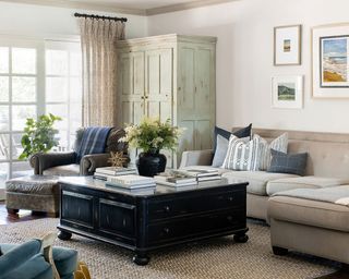 Living room with subtle pattern pops including textured carpet and taupe upholstered sofa