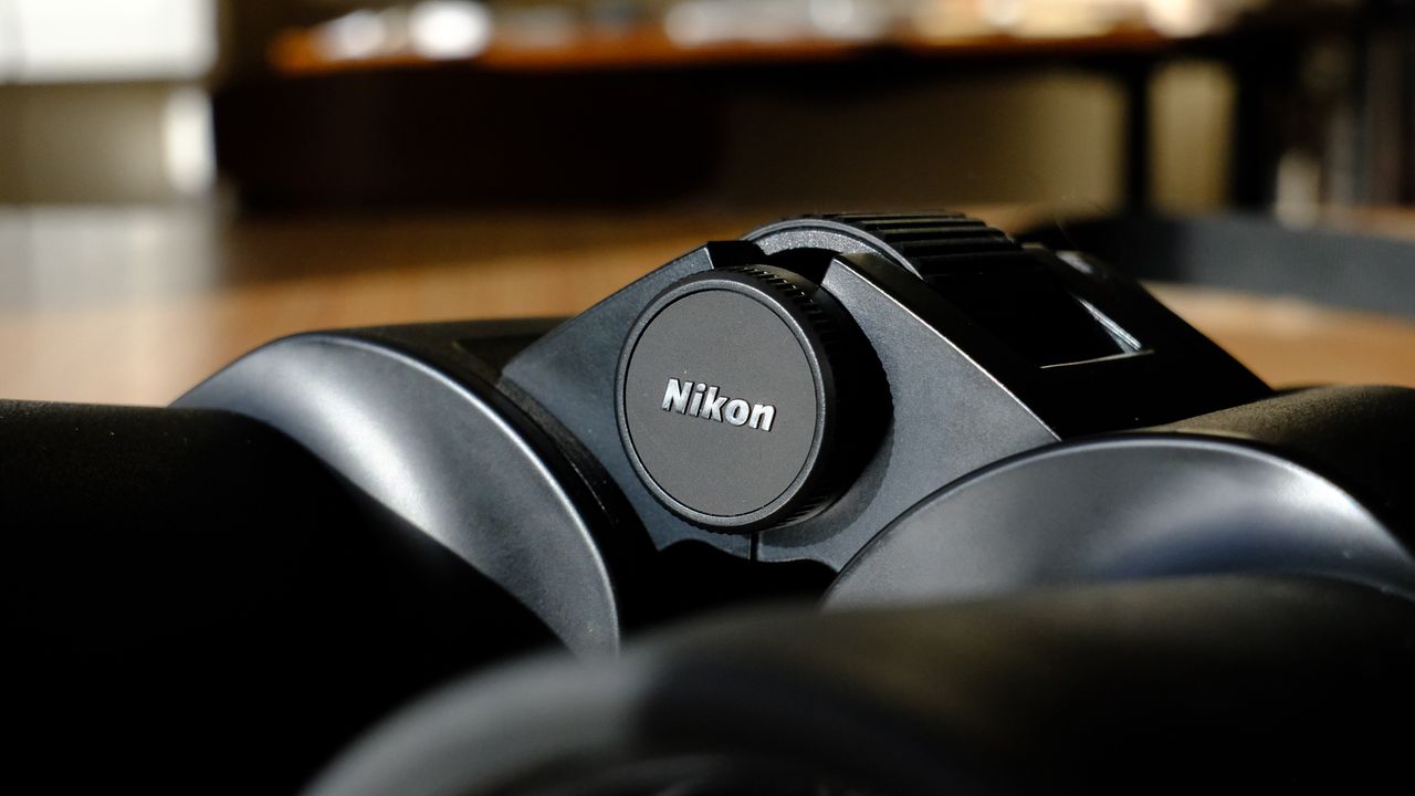 The Nikon logo in between the barrels on the Nikon Action 16x50 binoculars.