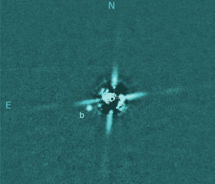 A direct image captured by the Subaru Telescope of the newfound exoplanet 2M0437b, a gas giant that circles a star 417 light-years from Earth. The extremely bright host star has been mostly removed by image-processing techniques; the four &quot;spikes&quot; are artifacts produced by the telescope&#039;s optics.