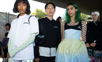 Models wear white t-shirt, black sweater and black and white dress with pink, moon patterned top