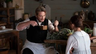 Juliette Binoche as Eugénie and Benoît Magimel as Dodin Bouffant cooking together in a still from the movie A Taste of Things