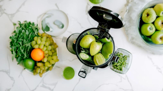 Nama Juicer and fresh fruit on the countertop