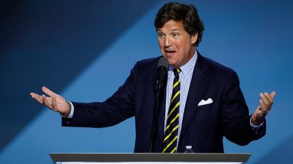 Tucker Carlson speaks on stage at the Republican National Convention on July 18, 2024